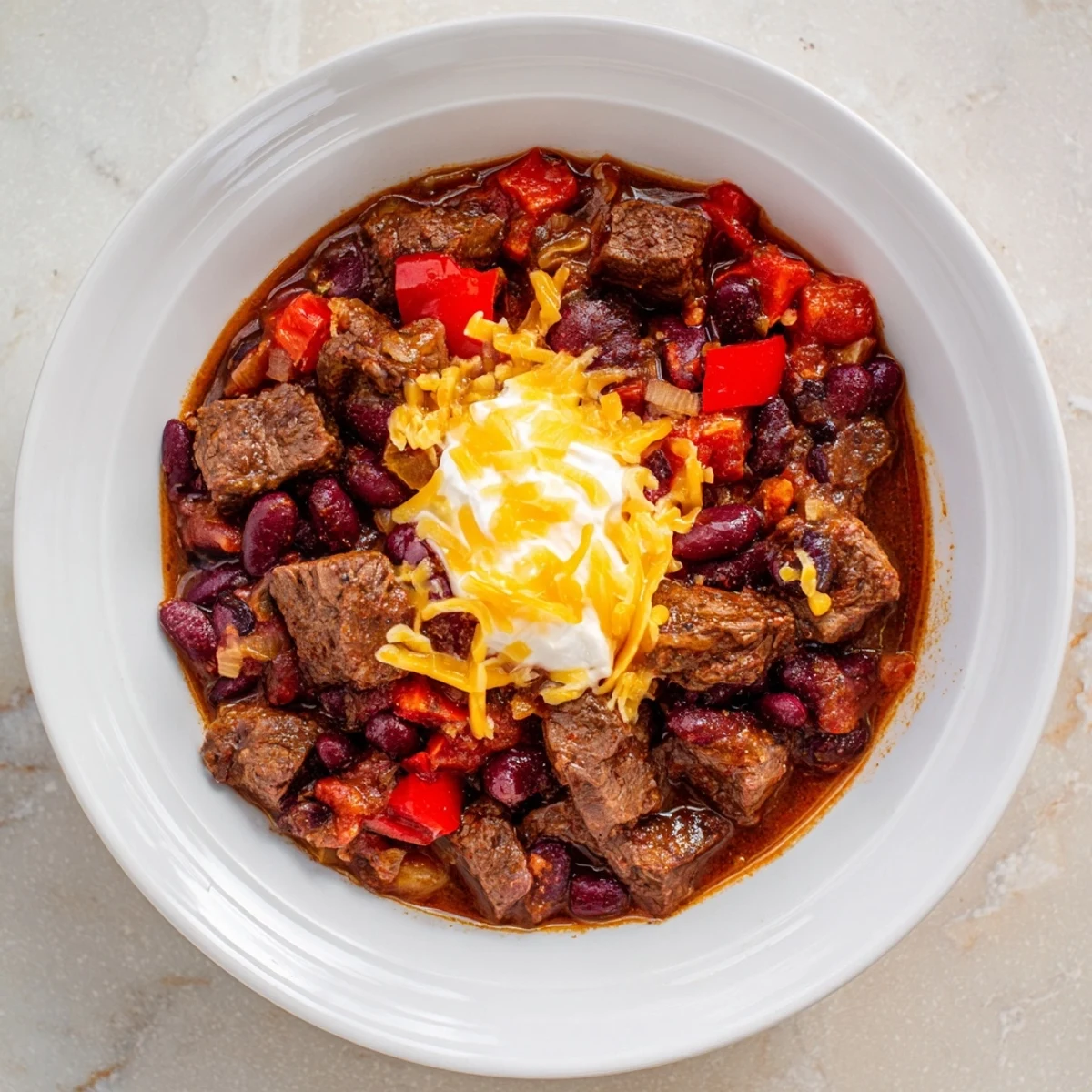 Serving suggestion for Slow Cooker Beef Chili with Beans, garnished with green onions, ready to enjoy with cornbread.