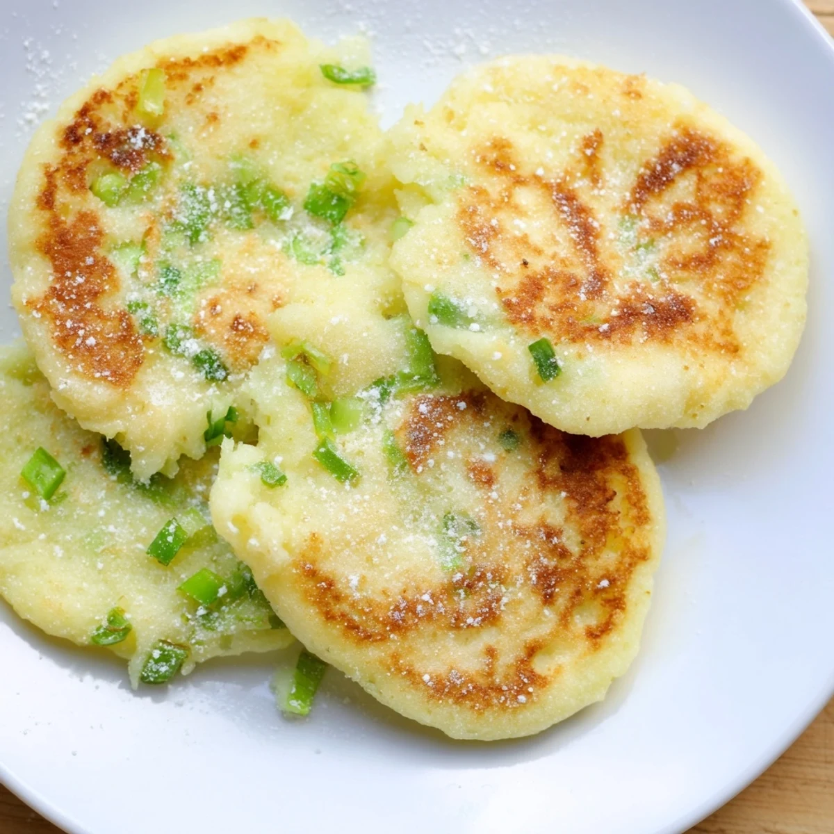 Freshly fried Irish Potato Cakes with Scallions served warm with melting butter.  