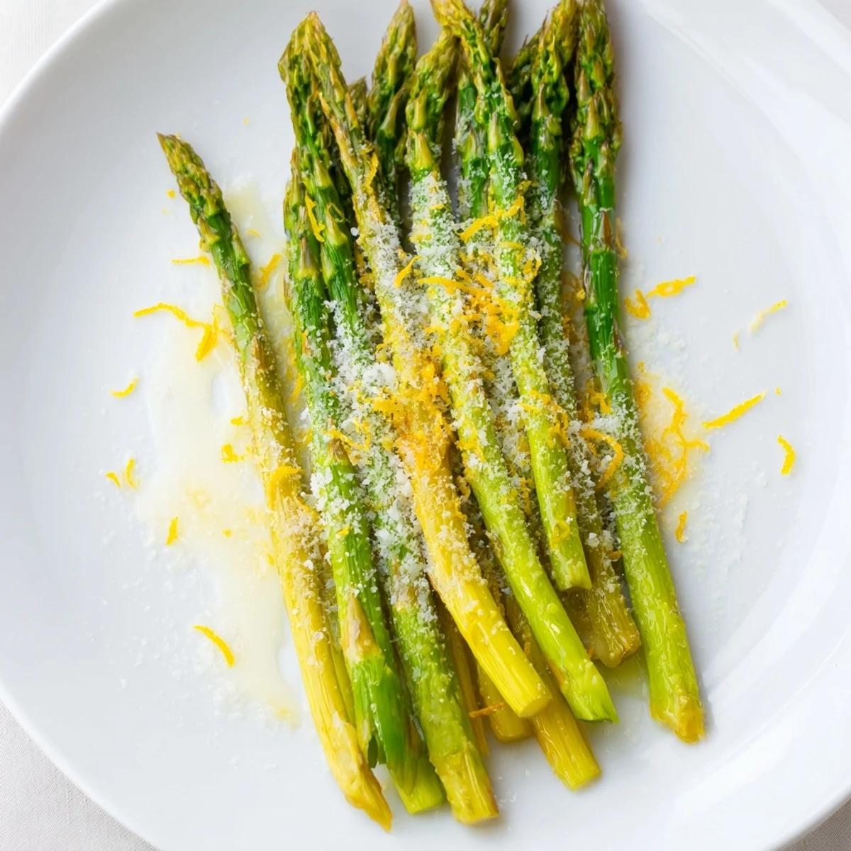 Close-up of tender roasted asparagus with Parmesan and lemon, highlighting its vibrant green color and juicy texture.