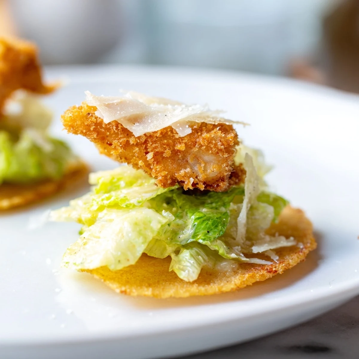 Crispy Chicken Caesar Salad Chips display golden baked potato chips topped with dressed romaine and crunchy chicken pieces.
