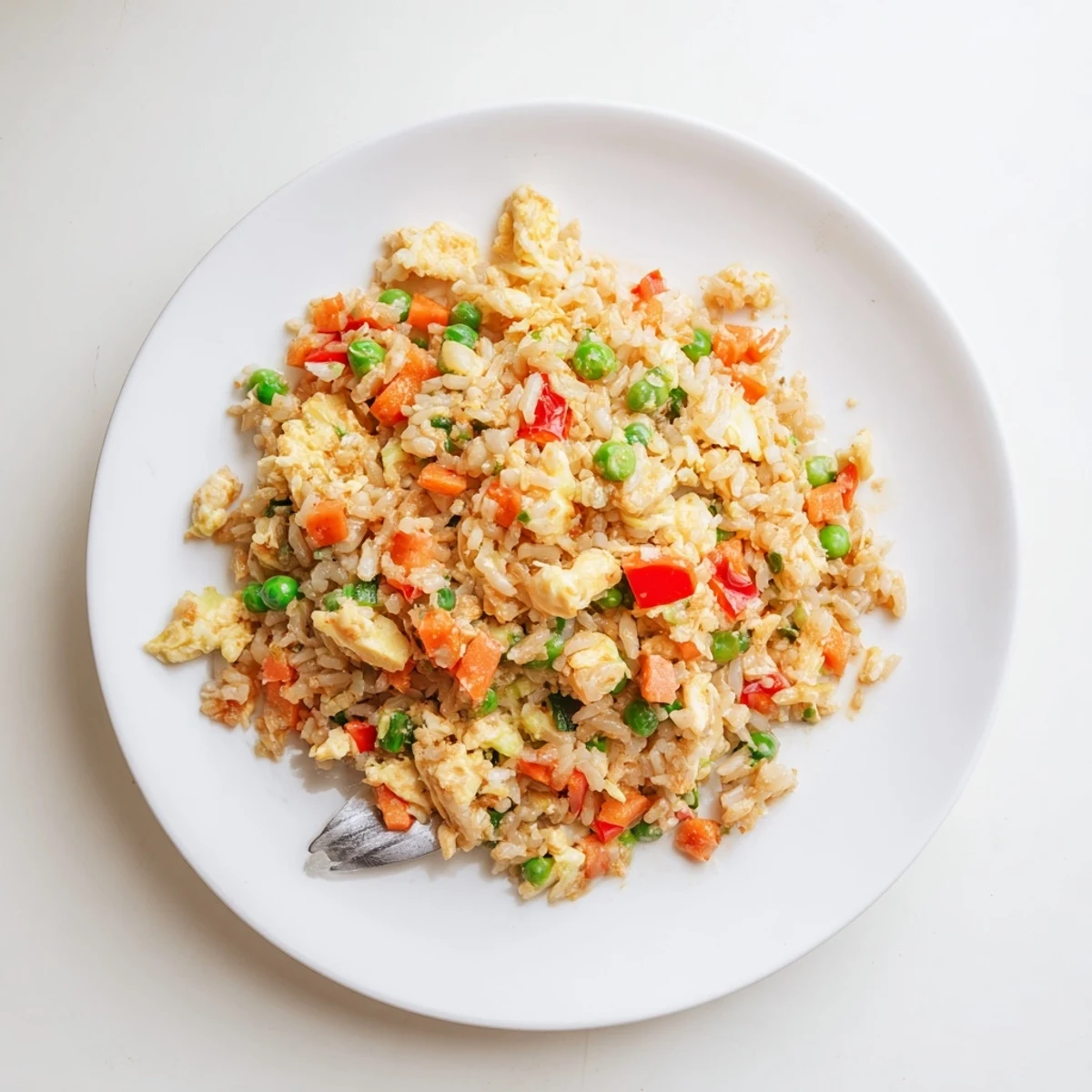 Wok-fried Bang Bang Fried Rice piles high with colorful peppers and peas, a quick weeknight vegetarian meal for families.
