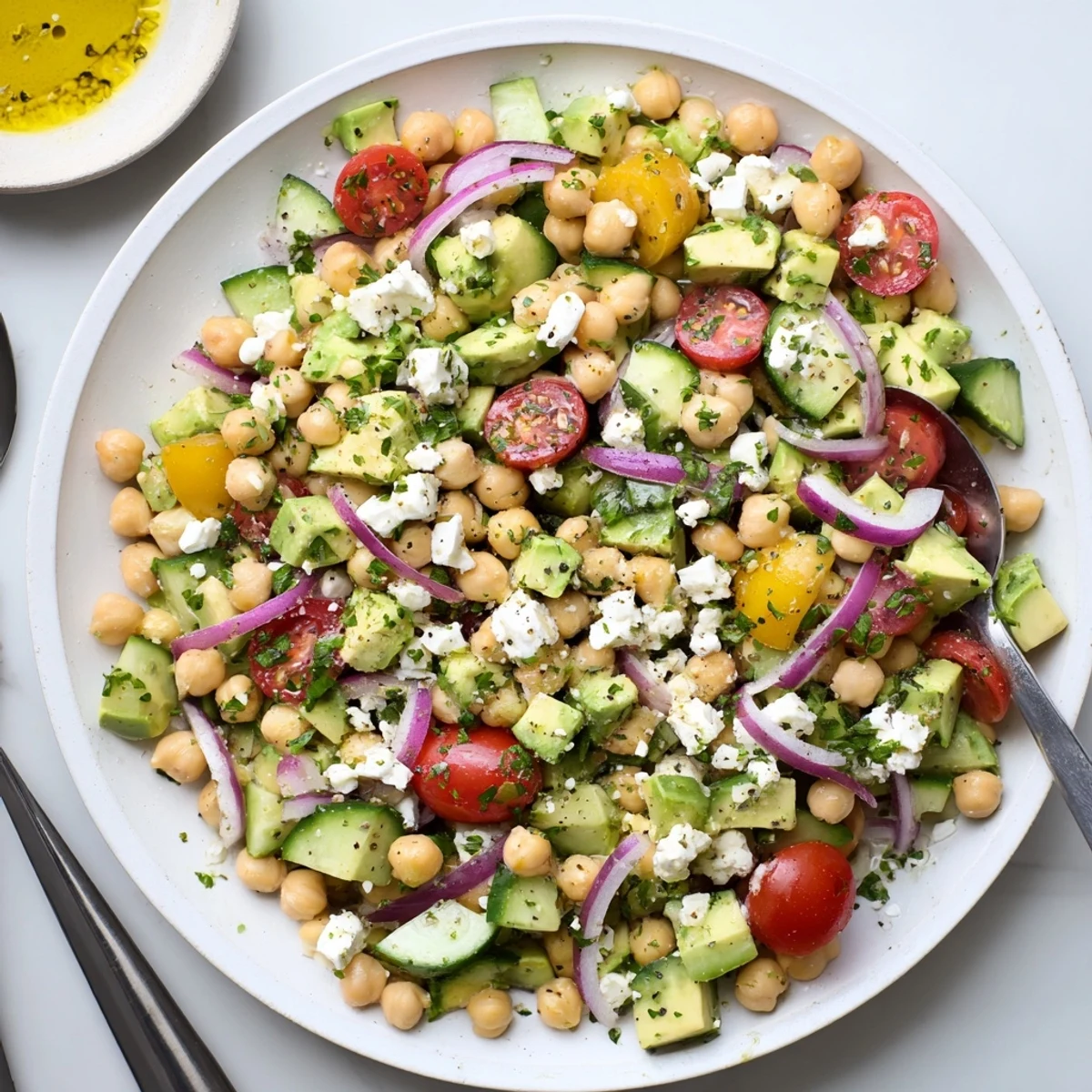 Creamy avocado, tangy feta, and chickpeas create a vibrant Chickpea Feta Avocado Salad tossed in zesty lemon dressing.