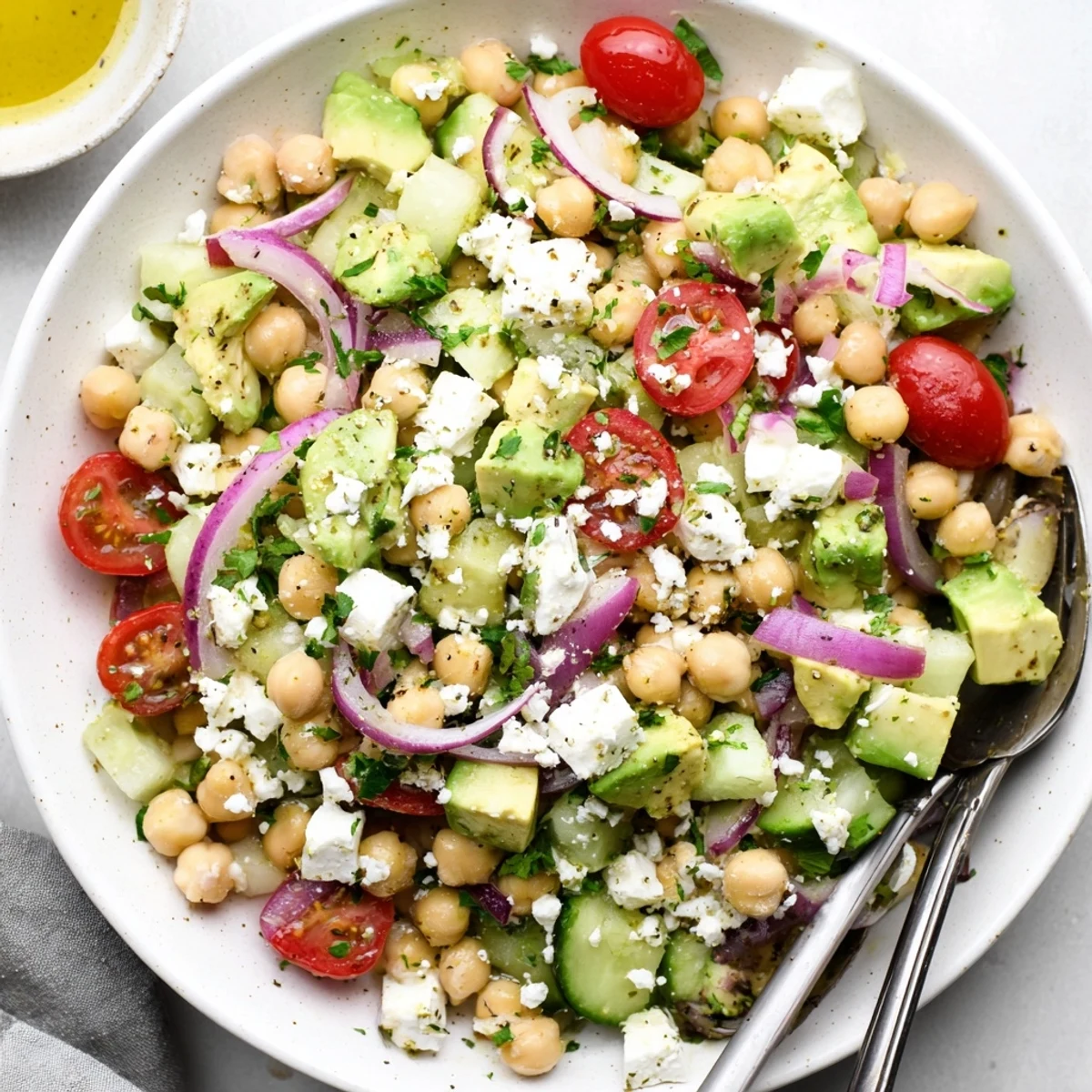 A hearty Chickpea Feta Avocado Salad with avocado chunks, feta crumbles, chickpeas, and a light lemon vinaigrette.