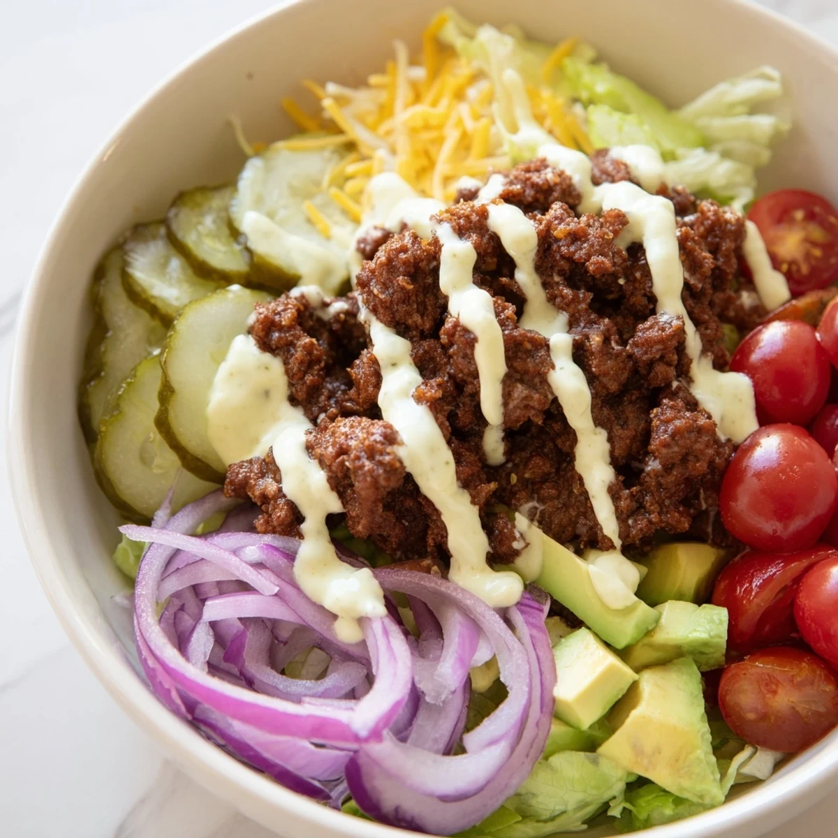 Delicious burger bowls featuring juicy beef, cheddar cheese, and creamy homemade sauce