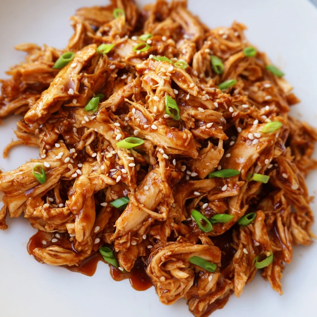 Tender slow cooker Mongolian chicken glazed in glossy brown sauce over fluffy white rice