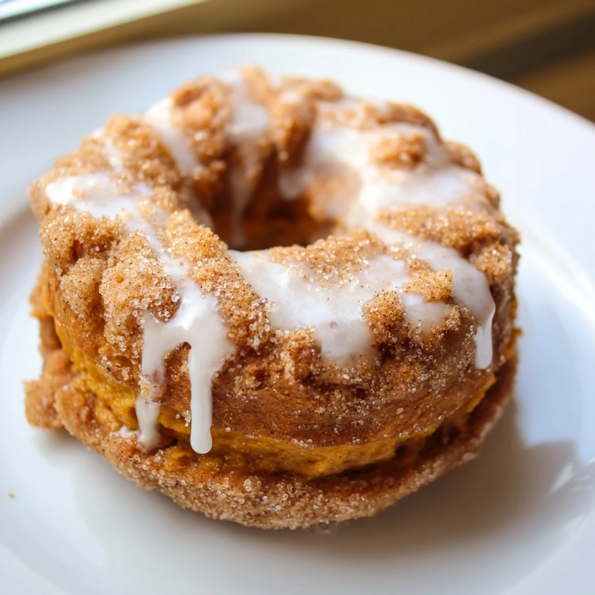 Soft fried donuts made with biscuit dough filled with warm pumpkin spice mixture