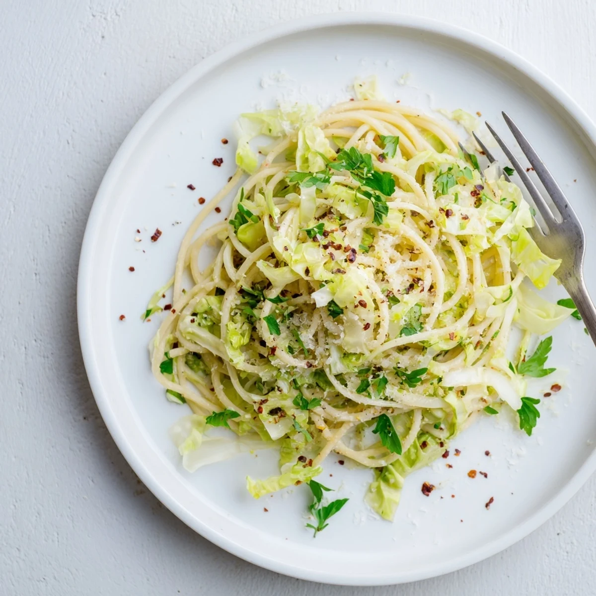 Twirled spaghetti noodles with tender caramelized cabbage slices brightened by zesty lemon and aromatic garlic