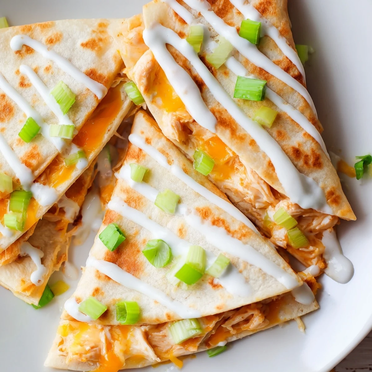 Half-moon flour tortilla packed with buffalo chicken and jack cheese topped with cooling ranch sauce