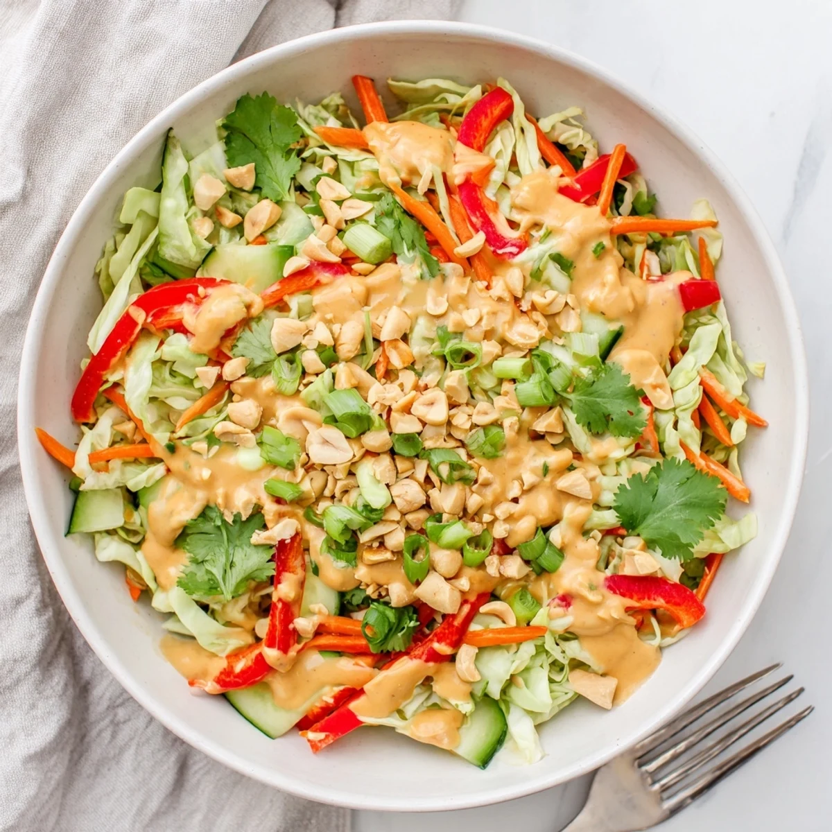 Creamy peanut sauce coats shredded cabbage and carrots in this vibrant Thai salad peanut sauce