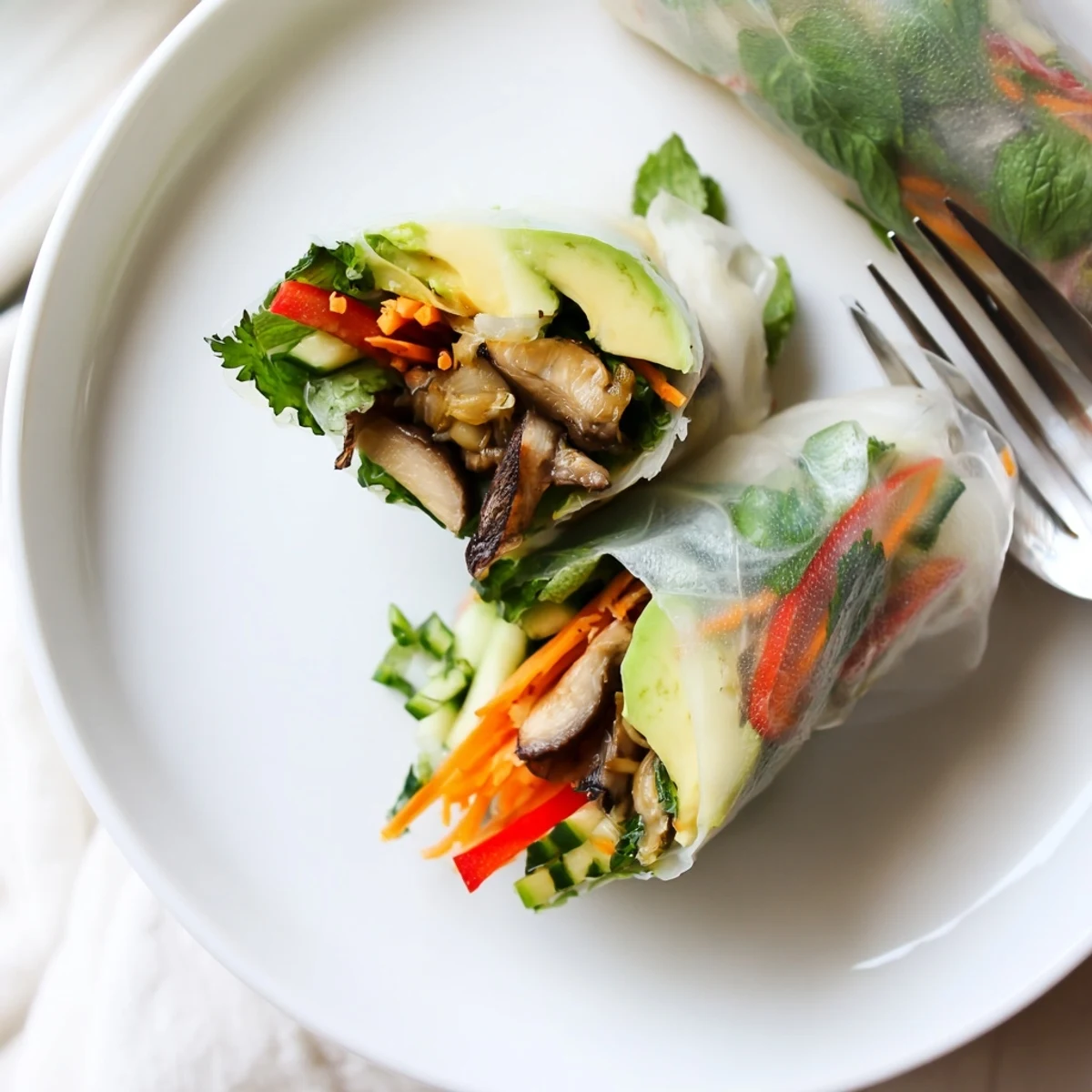 Avocado shiitake spring rolls with colorful vegetables served with dipping sauce