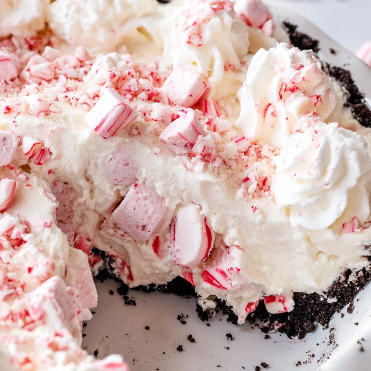 Slices of Candy Cane Pie chilled, fluffy whipped topping, and peppermint crunch