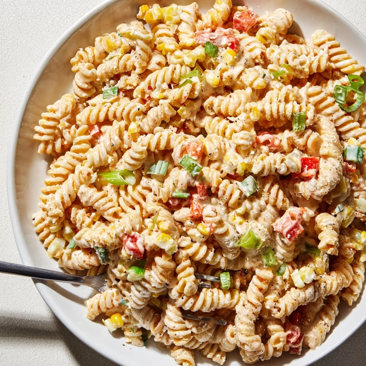 Street Corn Pasta Salad with charred corn, zesty lime, and crumbled Cotija.