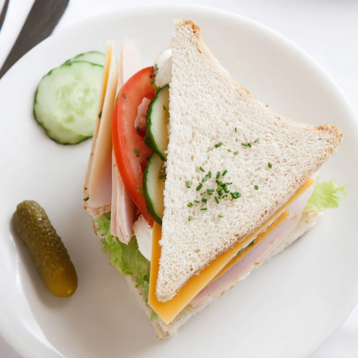 Mini Sandwiches arranged on a platter, soft bread, crisp cucumber slices