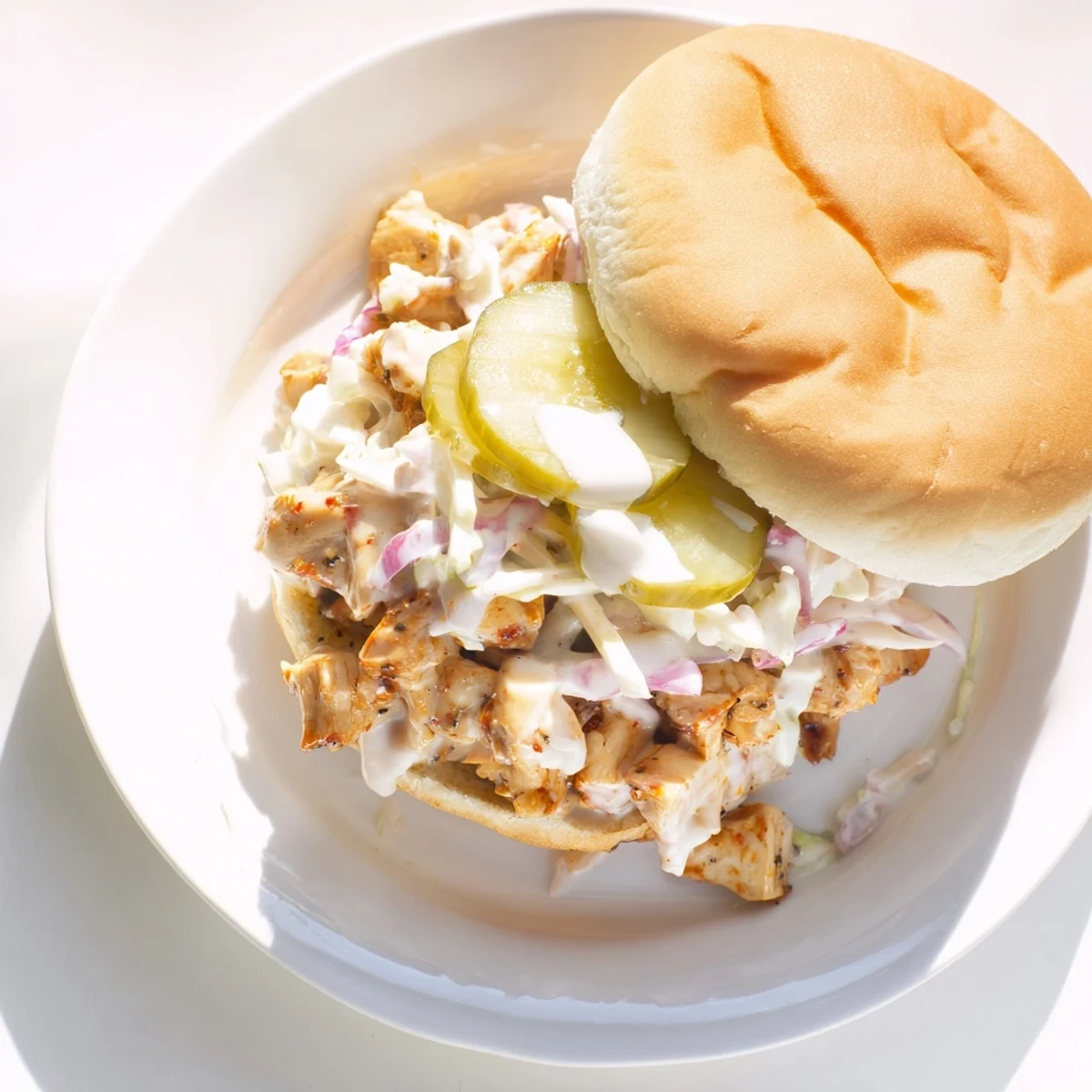 Savory Alabama BBQ Chicken Sandwich topped with crisp coleslaw and tangy white barbecue sauce