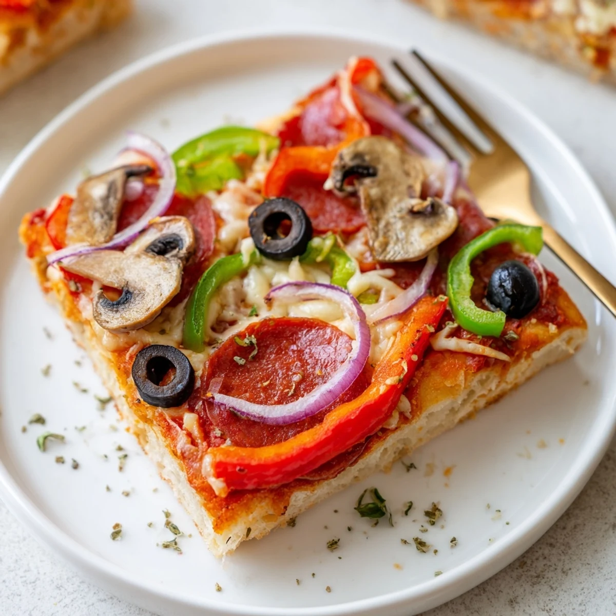 Crispy bottom Focaccia Pizza Supreme piled with peppers, olives, mushrooms, ready to slice