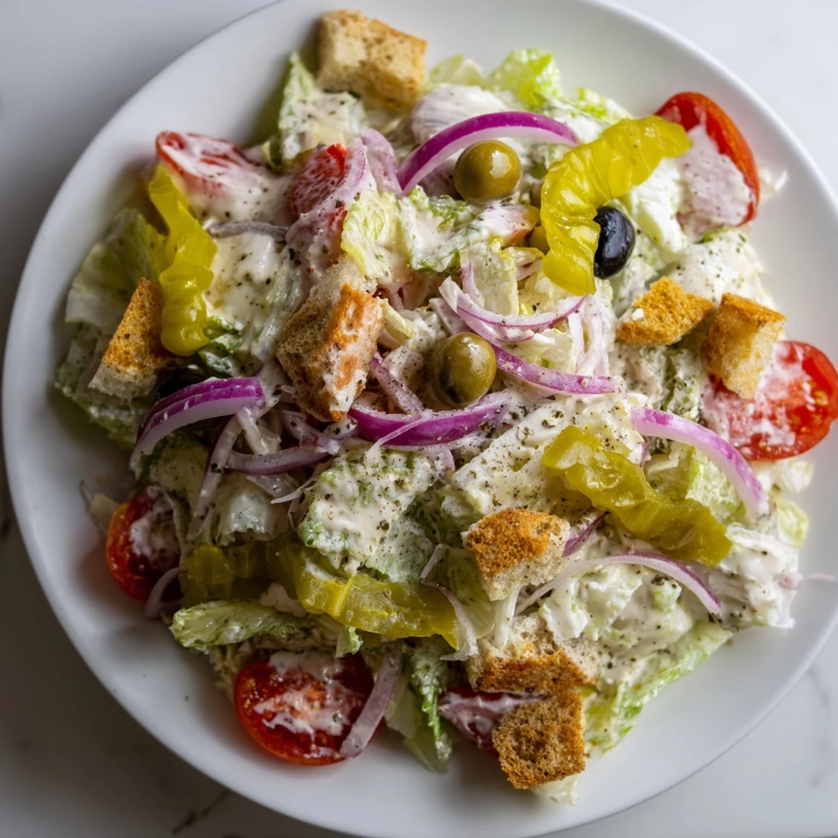 Fresh Olive Garden Salad in a bowl with crunchy croutons and pepperoncini